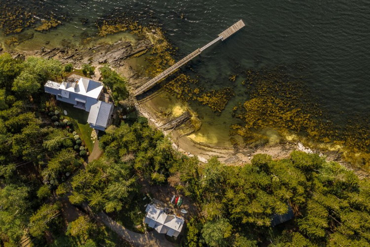 Drone view of a home and boat house built by Oceanside Builders, Maine